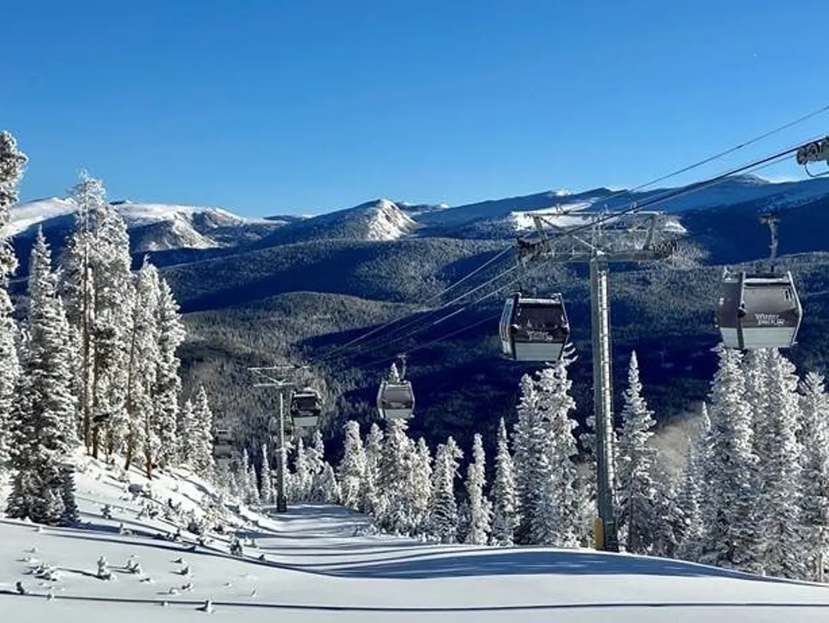 This image features the iconic gondolas ascending over a snow-blanketed landscape, with mountain peaks rising in the distance. The scene is serene yet filled with anticipation of alpine adventure.